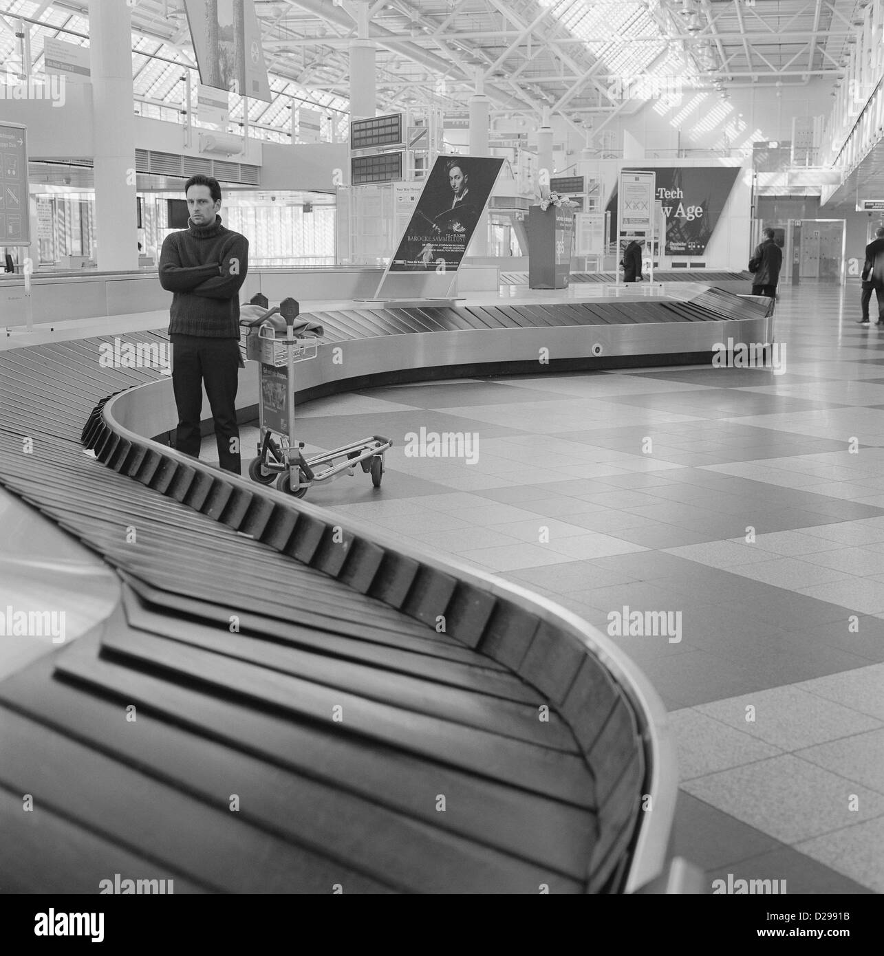 Young Man Waiting at the Baggage Claim License free except ads and outdoor billboards Stock Photo