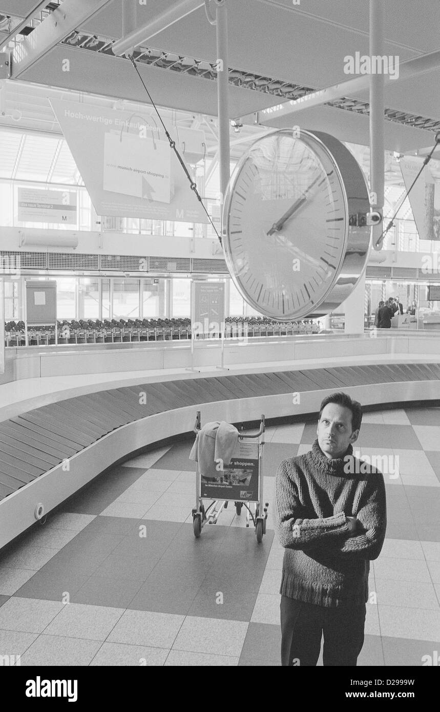 Young Man Waiting at the Baggage Claim License free except ads and outdoor billboards Stock Photo