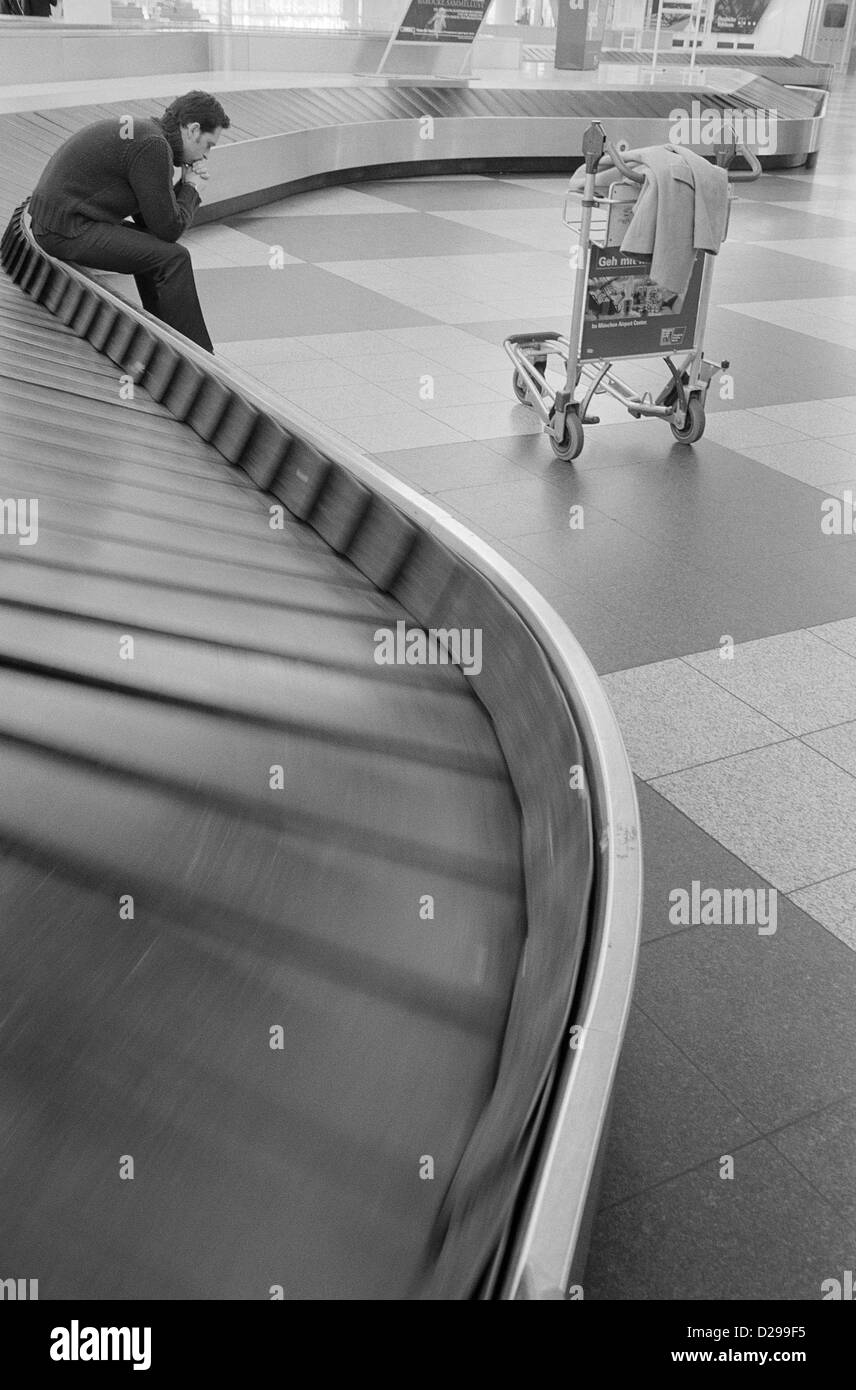 Young Man Waiting at the Baggage Claim License free except ads and outdoor billboards Stock Photo