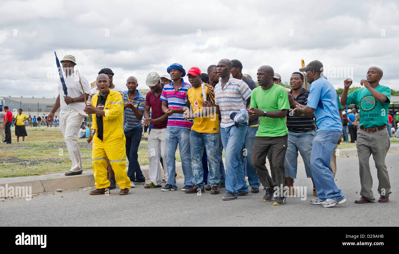 RUSTENBURG, SOUTH AFRICA - Mine workers stand outside the Khomanani Mine on January 16, 2013 in Rustenburg, South Africa. Anglo Platinum workers are refusing to work after the company announced that 14,000 jobs could be lost during a major restructuring of the company. (Photo by Gallo Images / Foto24 / Craig Nieuwenhuizen) Stock Photo