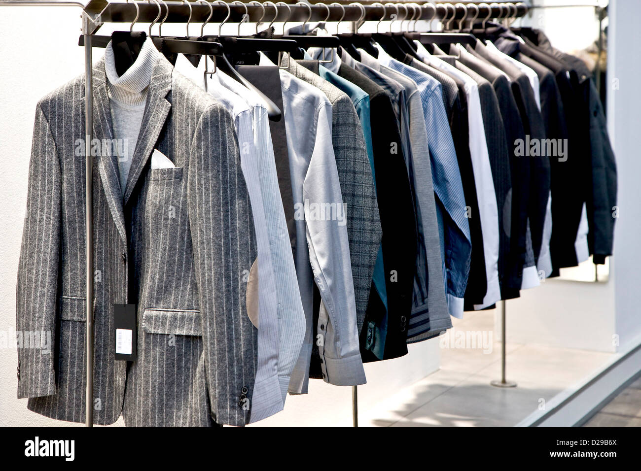 Rack of mens suits Stock Photo - Alamy