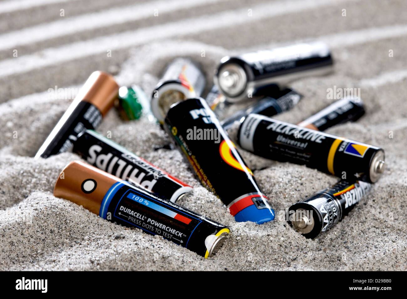 Battery waste on the beach Stock Photo
