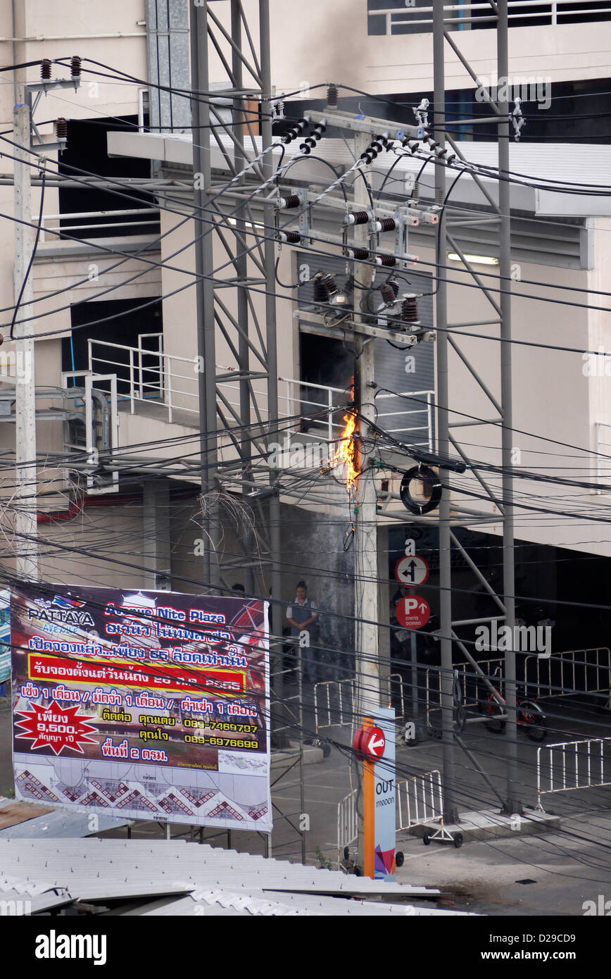 Outdoor electric power cables on fire outside The Avenue Shopping Mall car park in Pattaya Thailand Stock Photo