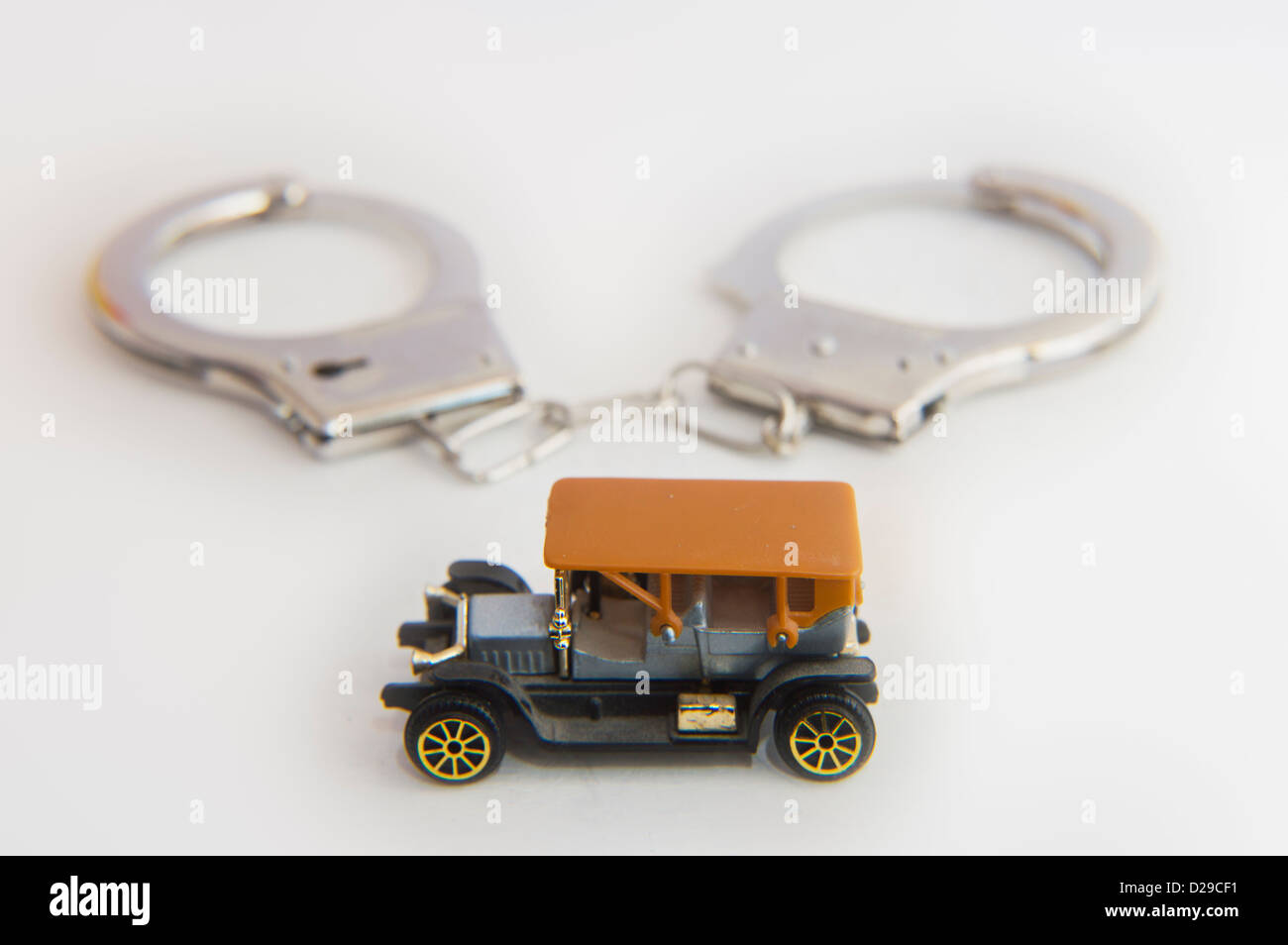 Concept image, old car, expense, motoring, handcuffs, trapped, ownership, costs Stock Photo