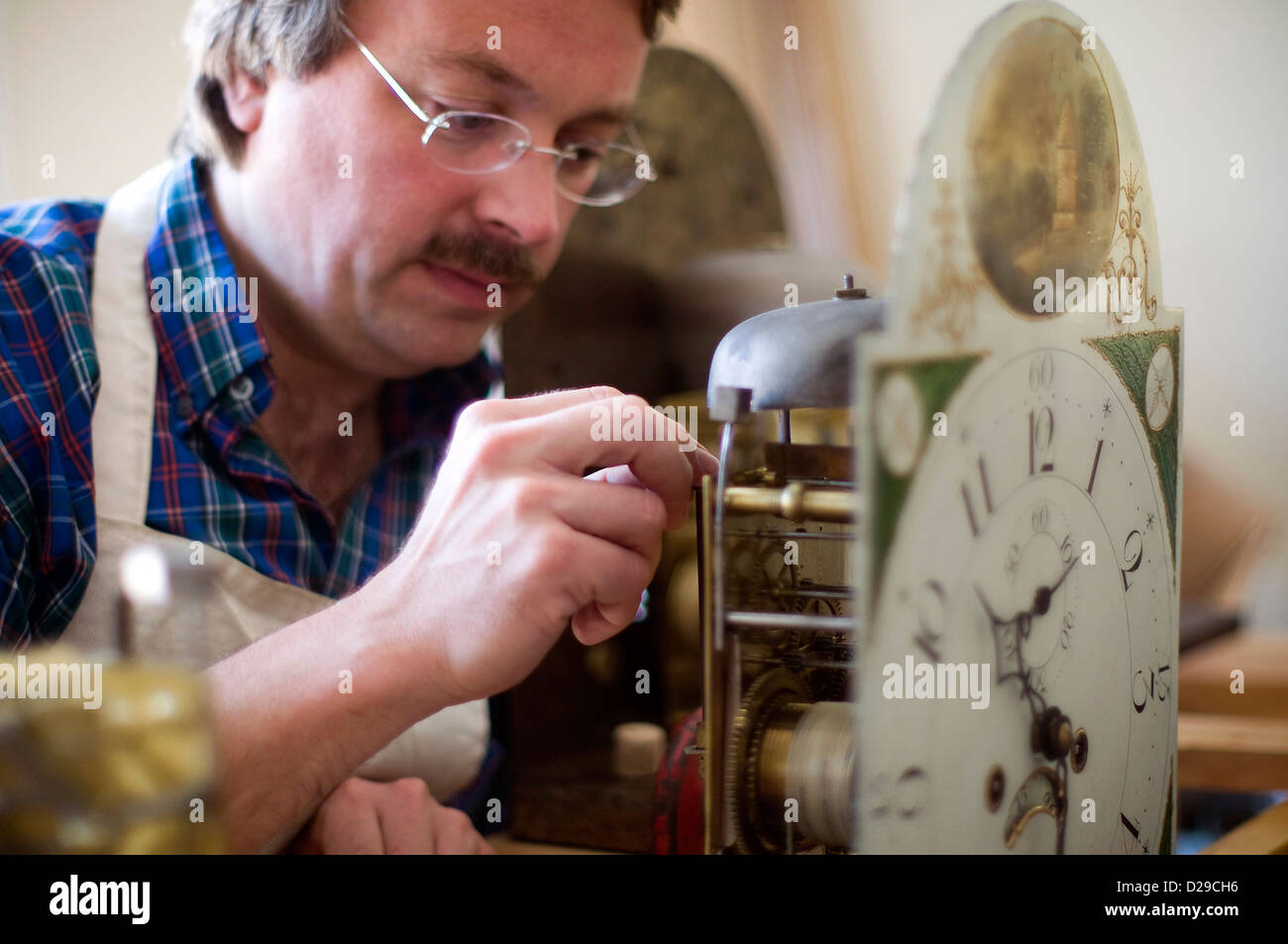 Student restoring antique clock at West Dean College, Chichester, West