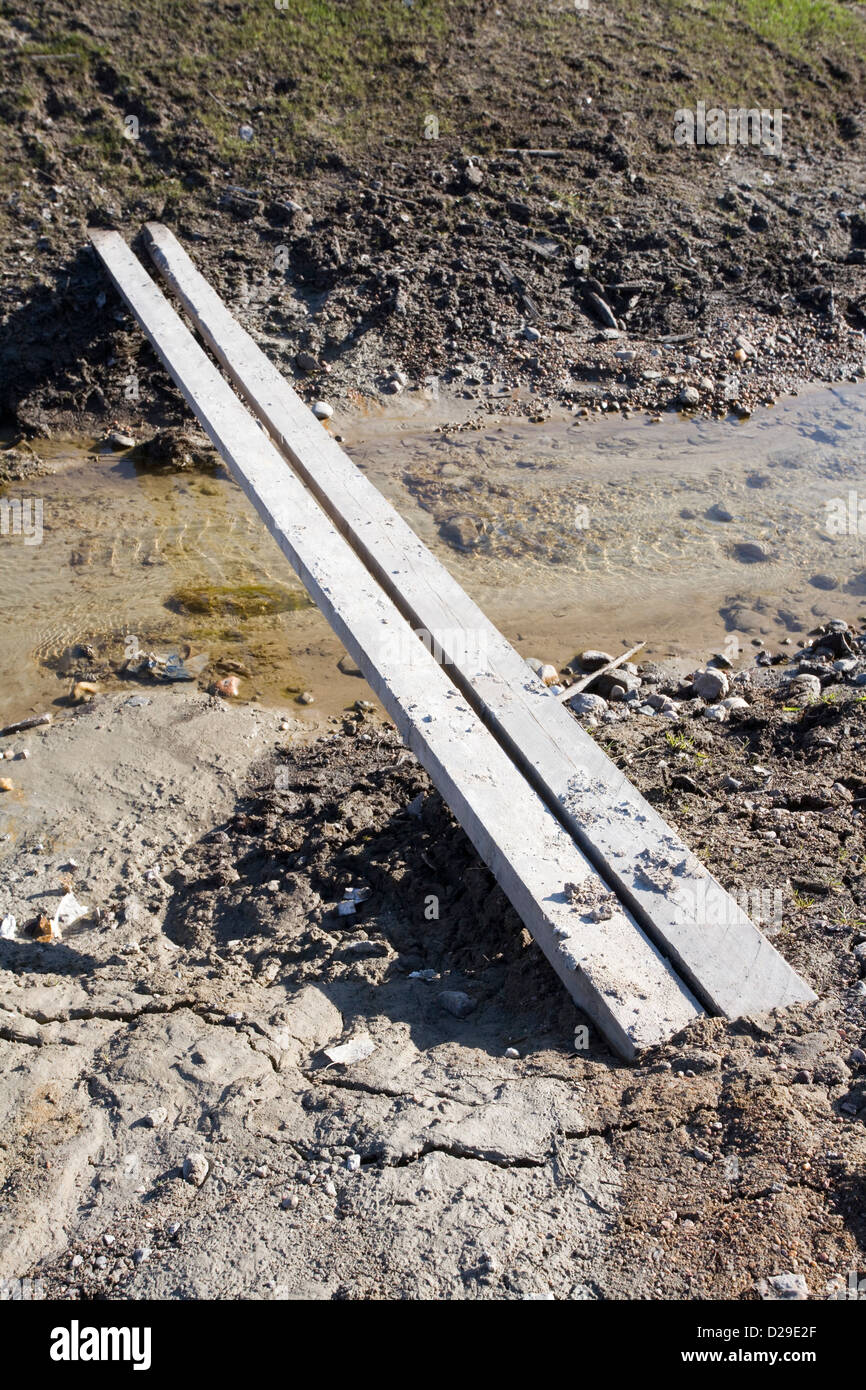 two planks crossing over ditch Stock Photo