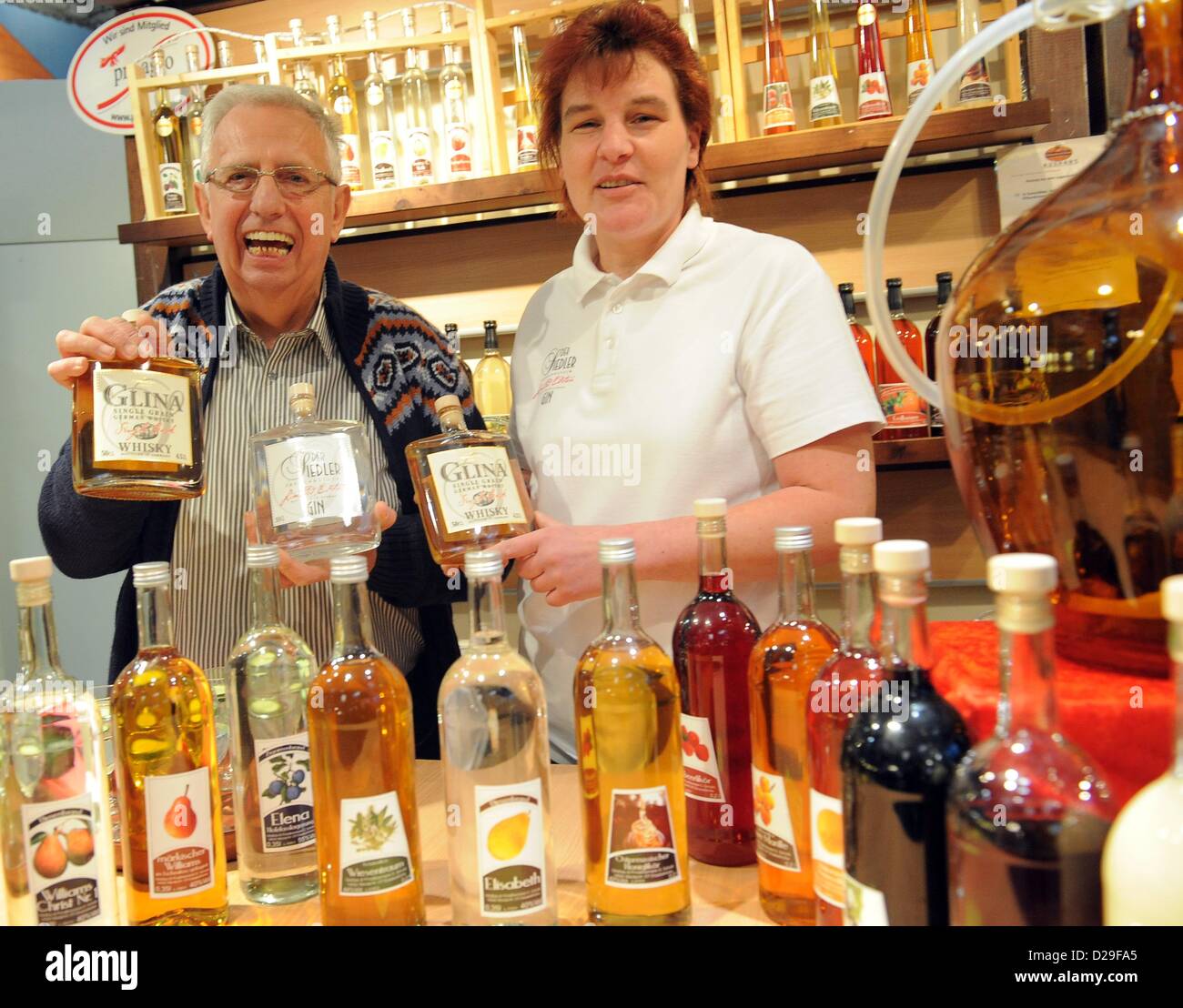 Guenter Schultz and Gritt Dinter from the private distiller Schulz in Werder offer whisky and gin alongside their other fruit brandies at Green Week in Berlin, Germany, 17 January 2013. International Green Week opens its doors to the public from 18 until 27 January 2013. Photo: Bernd Settnik Stock Photo