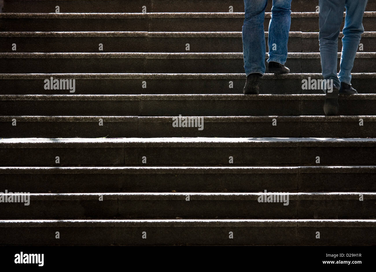Berlin, Germany, men in jeans go up the stairs Stock Photo