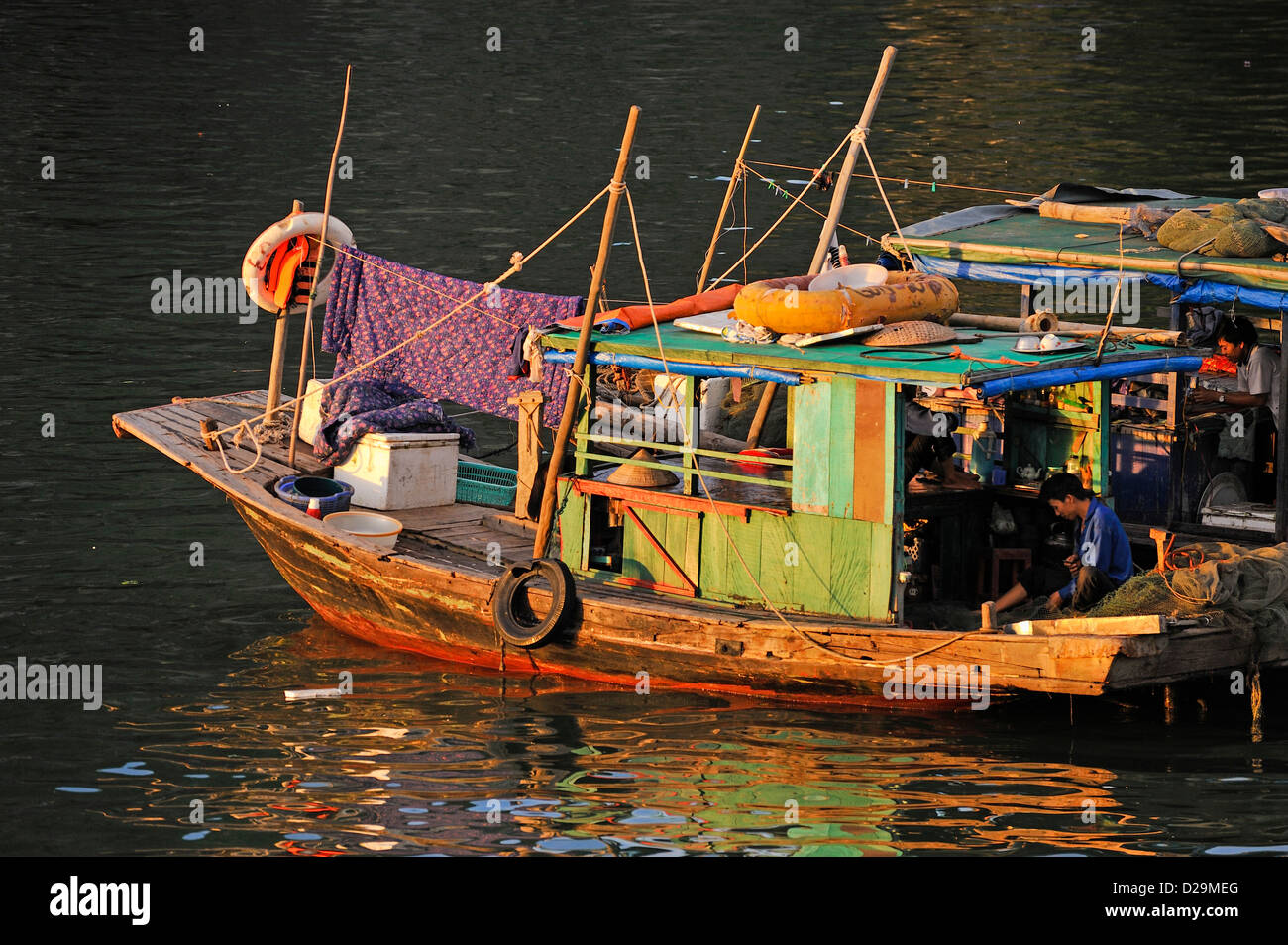 Ha long Bay, Vietnam at sunset / dusk - fisherman Stock Photo