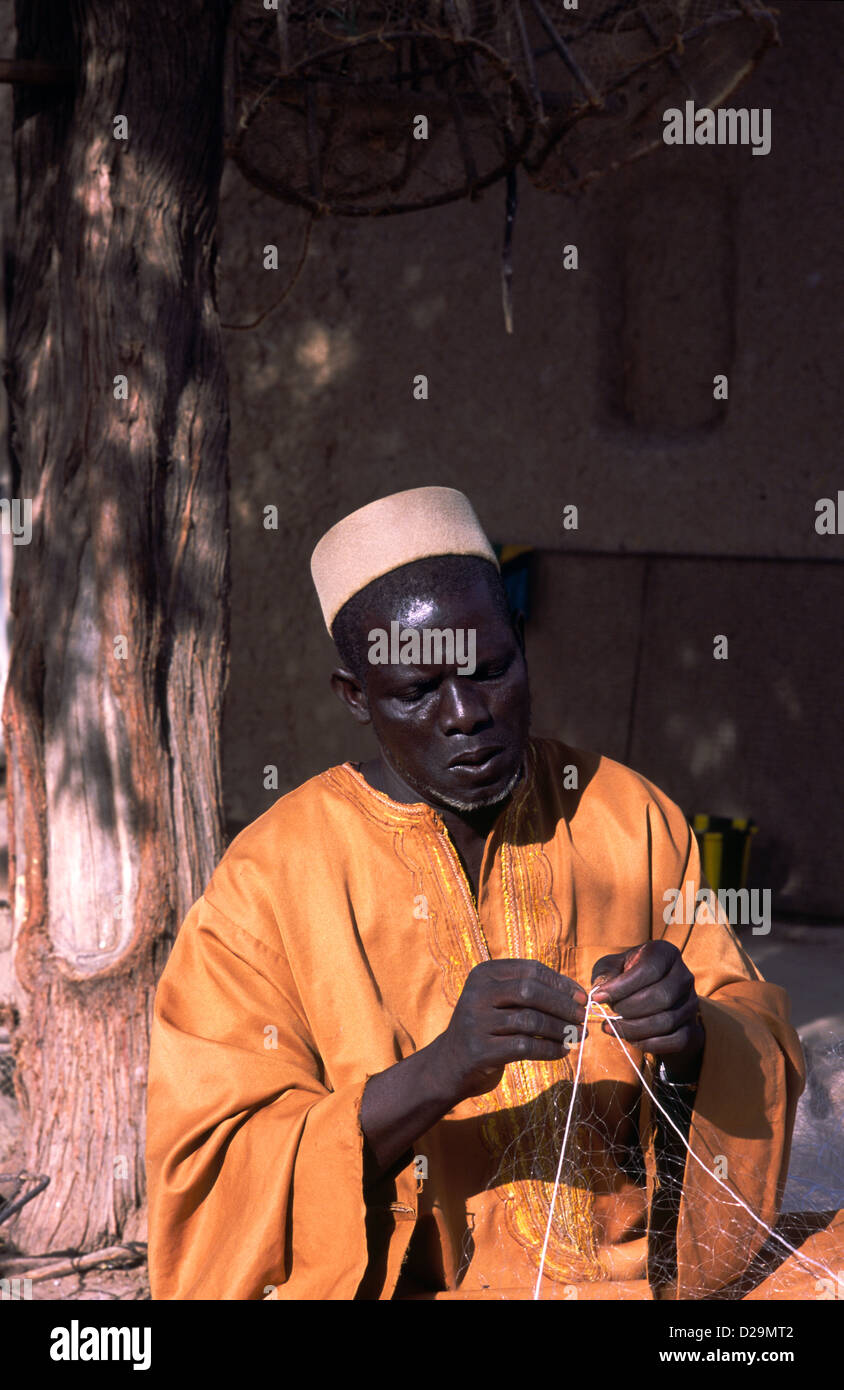 A Bozo fisherman preparing his nets in Mali, West Africa. Bozo are one of the ethnic groups in Mali. Stock Photo