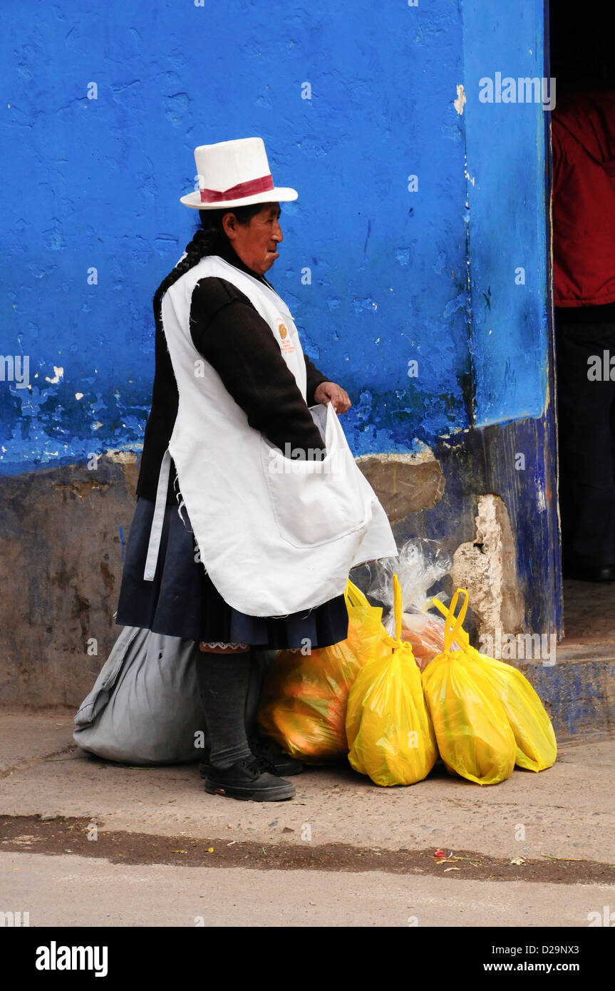 Woman And Blue Wall, Peru Stock Photo