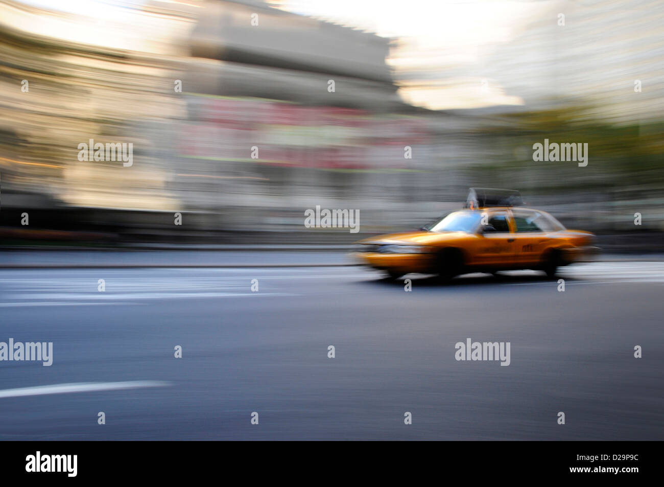Taxi cab speeding down street in a Stock Photo
