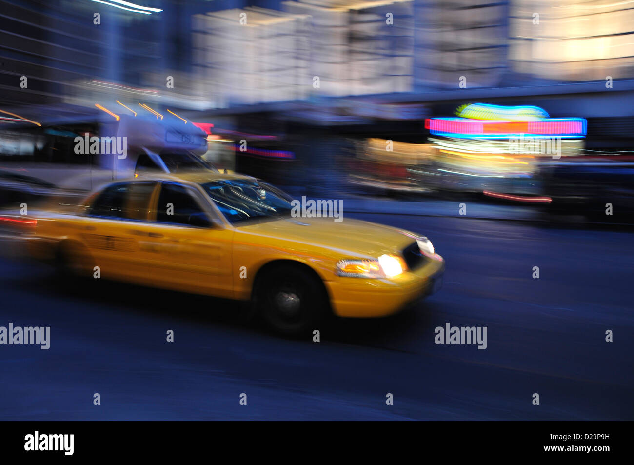 Taxi cab speeding down a city stree Stock Photo