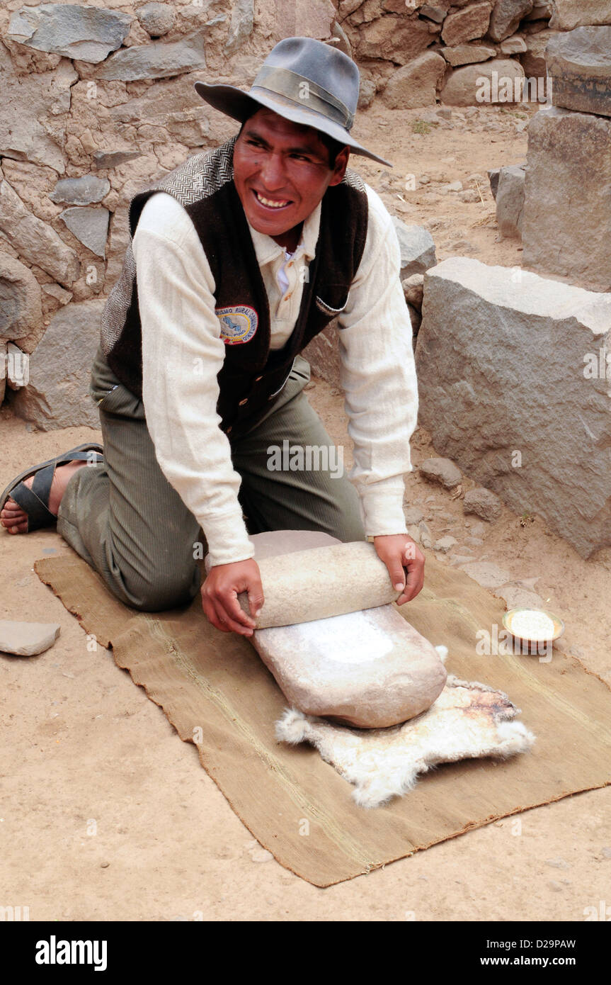 Farmer Grinding Flour By Hand, Peru Stock Photo