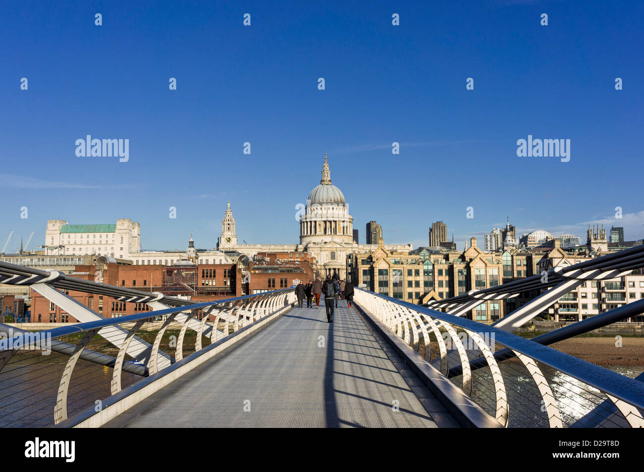 People walking across the Millennium Bridge towards St Pauls Cathedral, London, England, UK Stock Photo