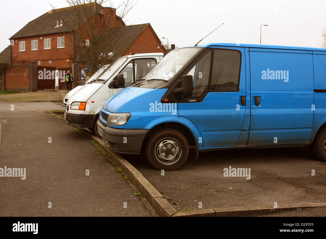 Builders vans, Ford Transits in a line near a construction site January 2013 Stock Photo