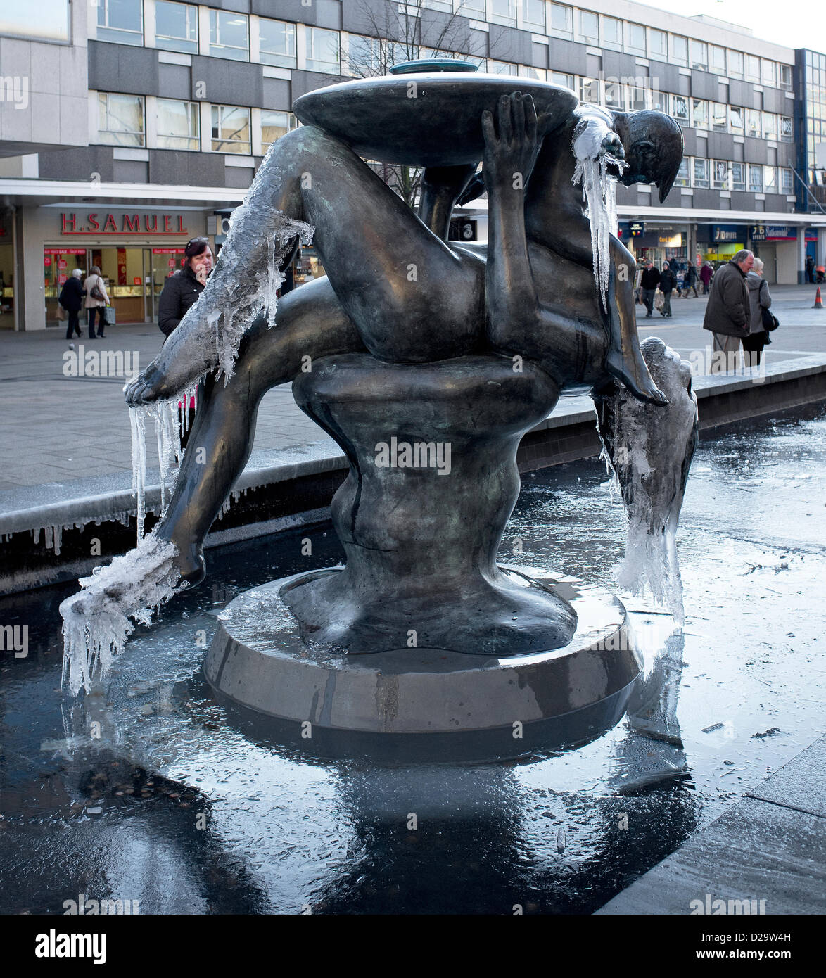 17th January, 2013. Freezing conditions hit Essex, UK. The popular Mother and Child fountain in Basildon Town Centre had to be turned off due to being covered in ice. Stock Photo