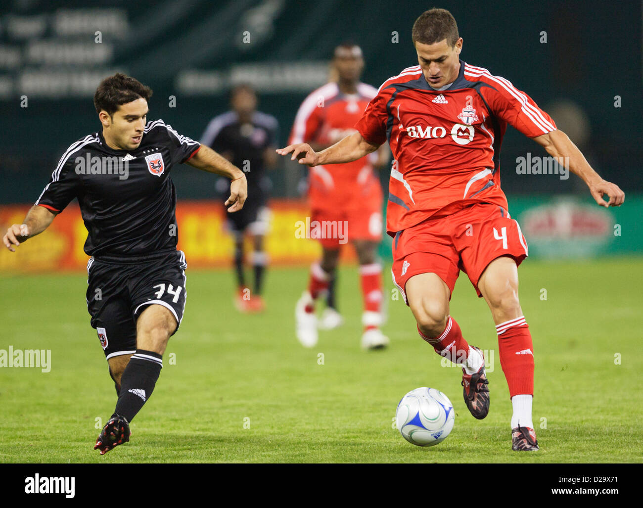 Marco Velez of Toronto FC (R) controls the ball against Franco Niell of DC United (L) during a Major League Soccer match. Stock Photo
