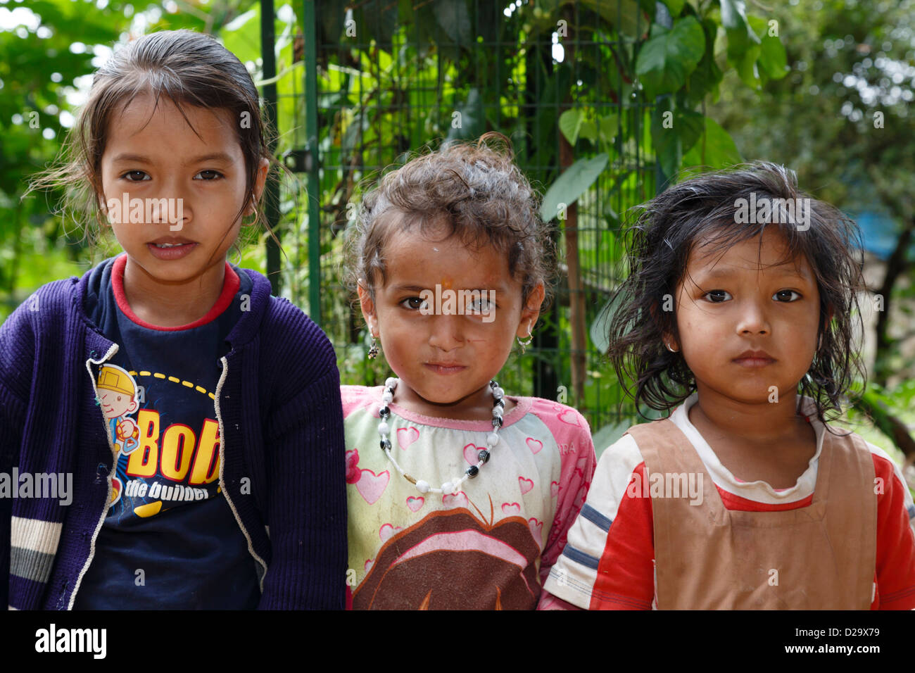 Three poor Indian children pose for a photo in Bangalore, India Stock Photo