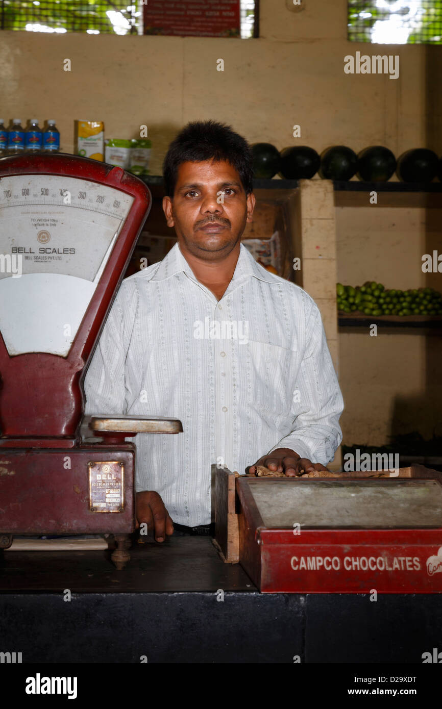 An independent vendor stands in his convenience store in Bangalore, India Stock Photo