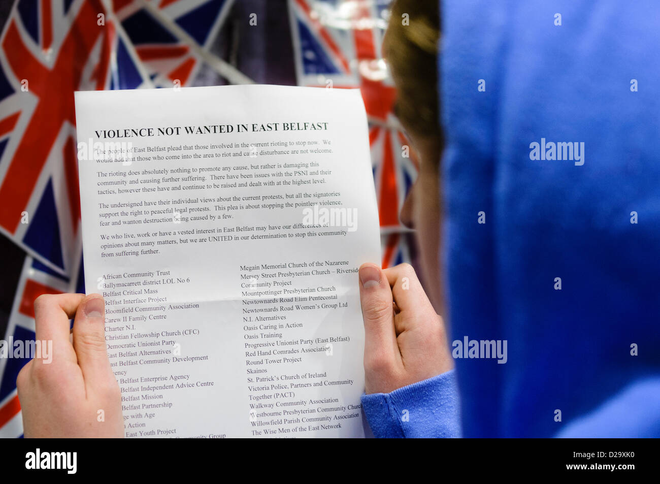 Belfast, UK. 17th January 2013.  A youth reads one of thousands of leaflets which are circulating around East Belfast, calling on the recent violence and rioting to stop. Credit:  Stephen Barnes / Alamy Live News Stock Photo