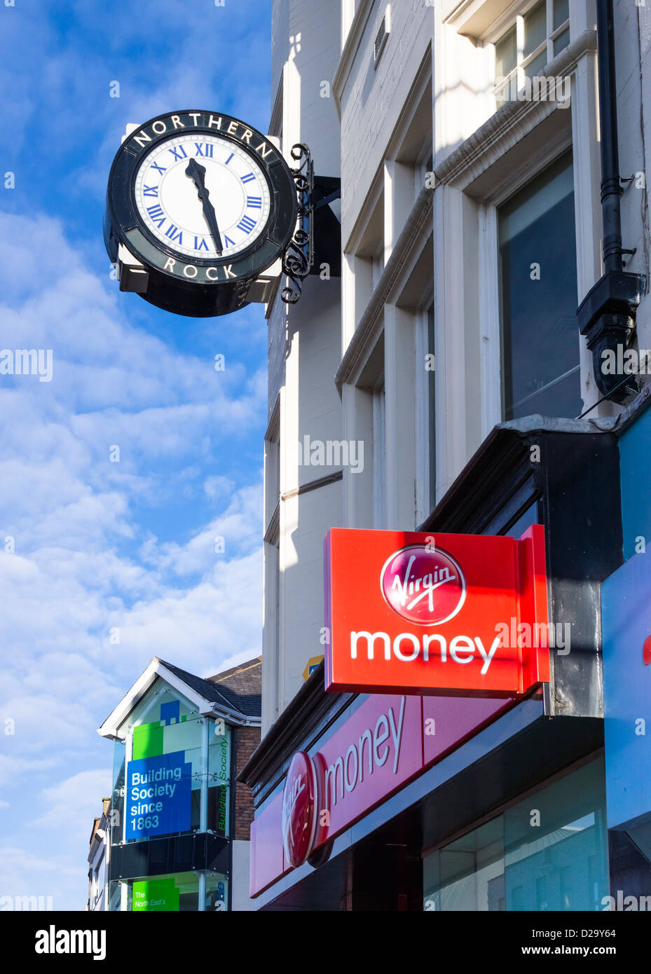 An old Northern Rock clock above the new Virgin Money sign. Stock Photo