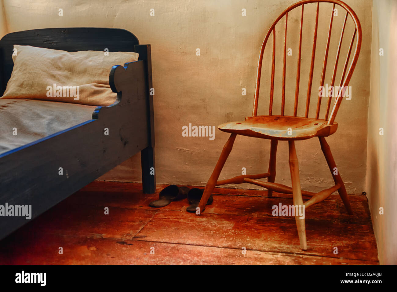 An antique chair and bed. Stock Photo