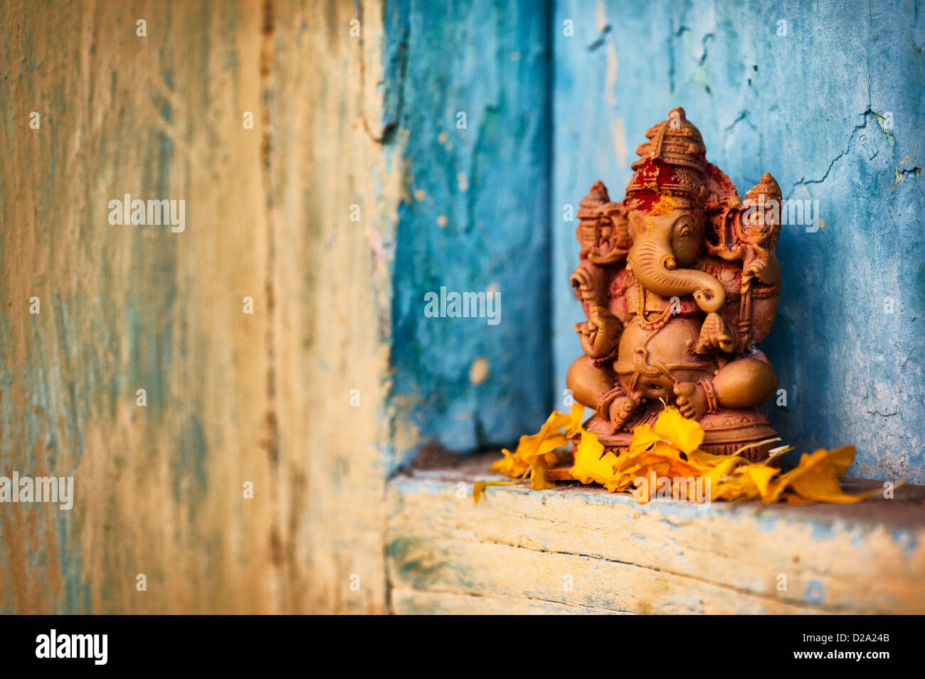 Hindu Elephant God. Lord Ganesha statue in and Indian house window Stock Photo