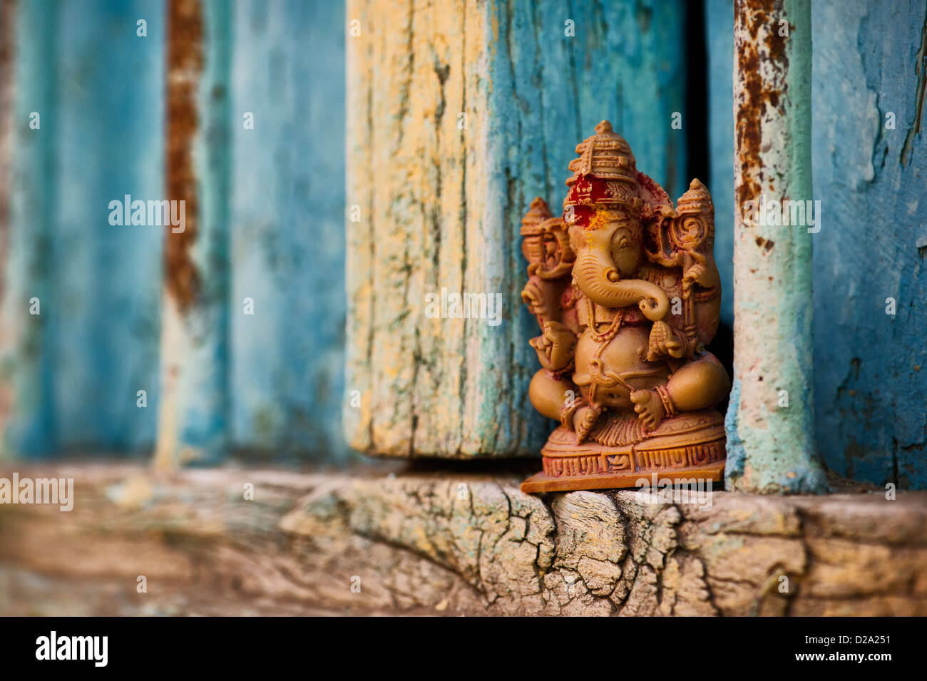 Hindu Elephant God. Lord Ganesha statue in and Indian house window Stock Photo