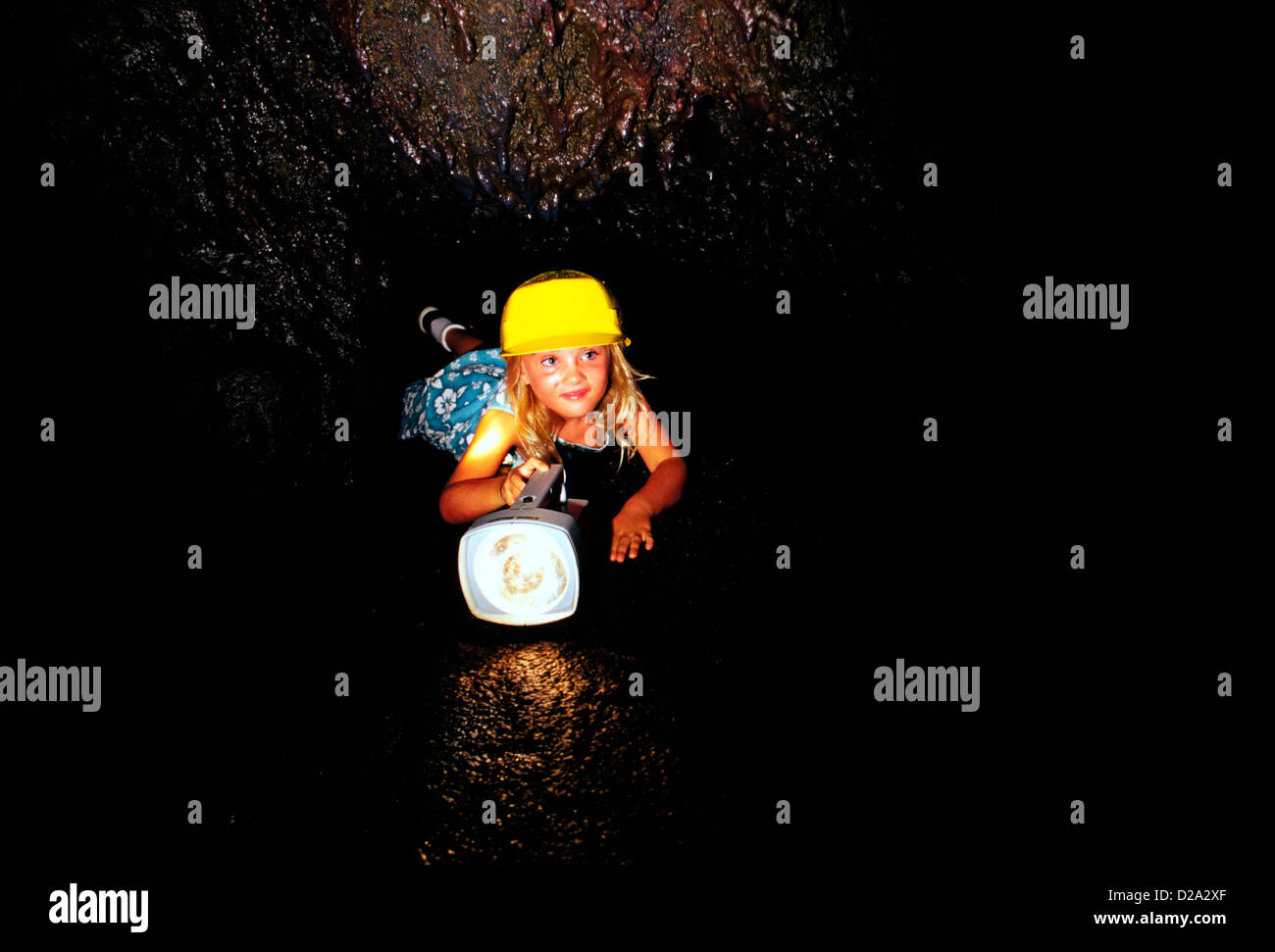 Girl Exploring Cave Stock Photo