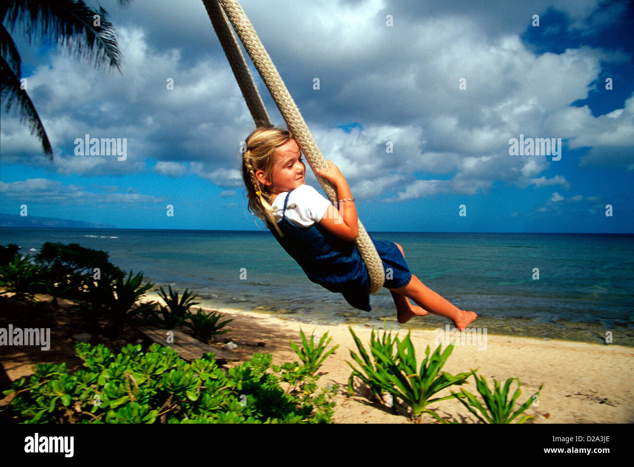 Girl (4) On A Rope Swing At Sunset Point On The North Shore Of Oahu, Hawaii Stock Photo Alamy