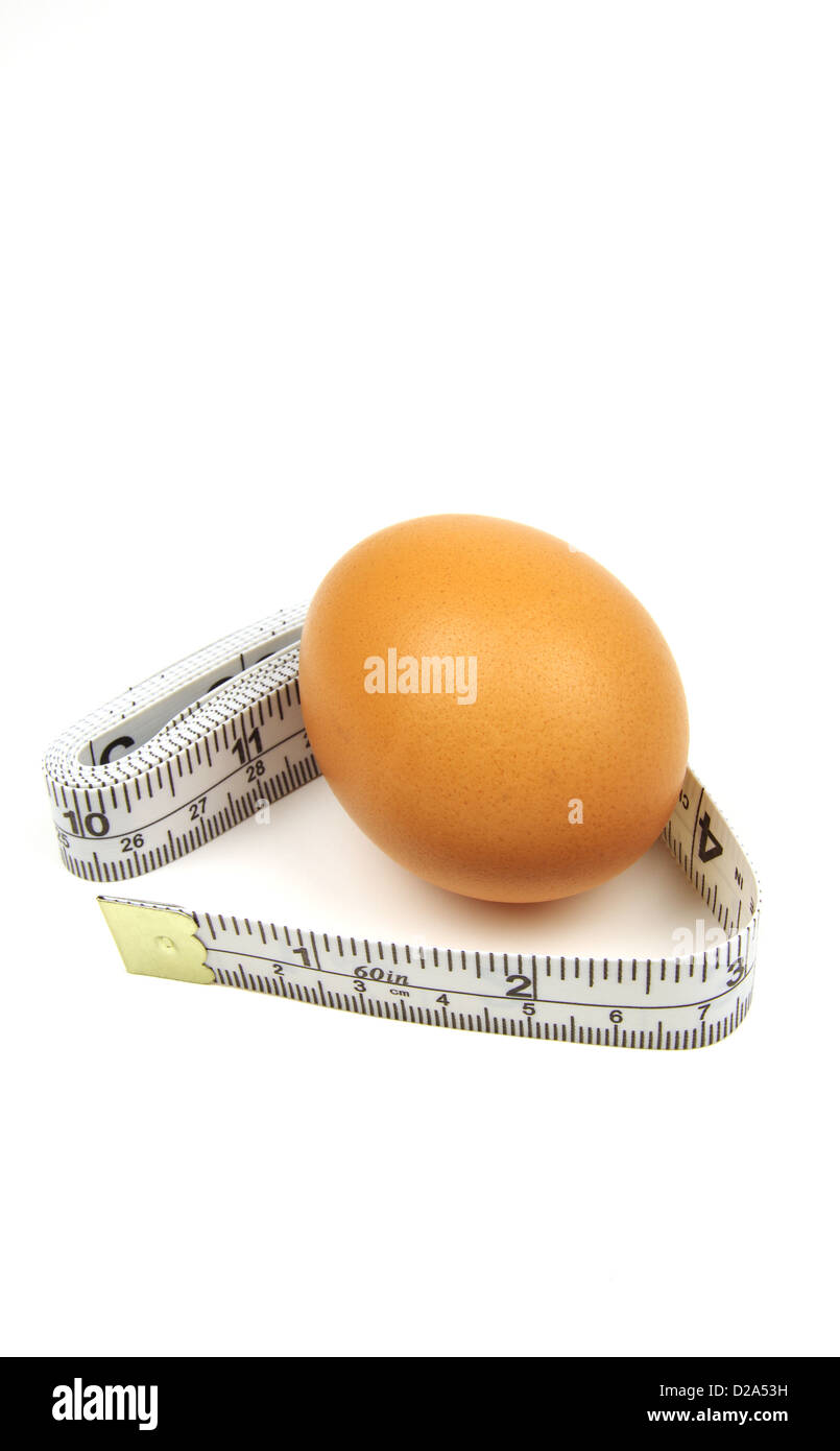 fresh brown egg and slimmers measuring tape Stock Photo