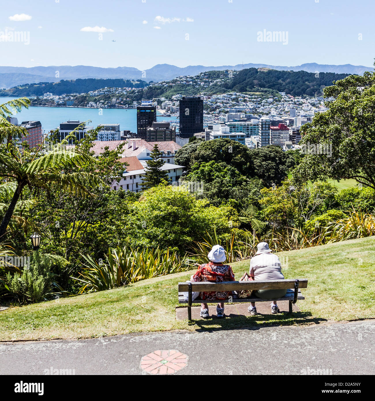 People on park seat at Botanical Gardens, overlooking Wellington New Zealand. Stock Photo