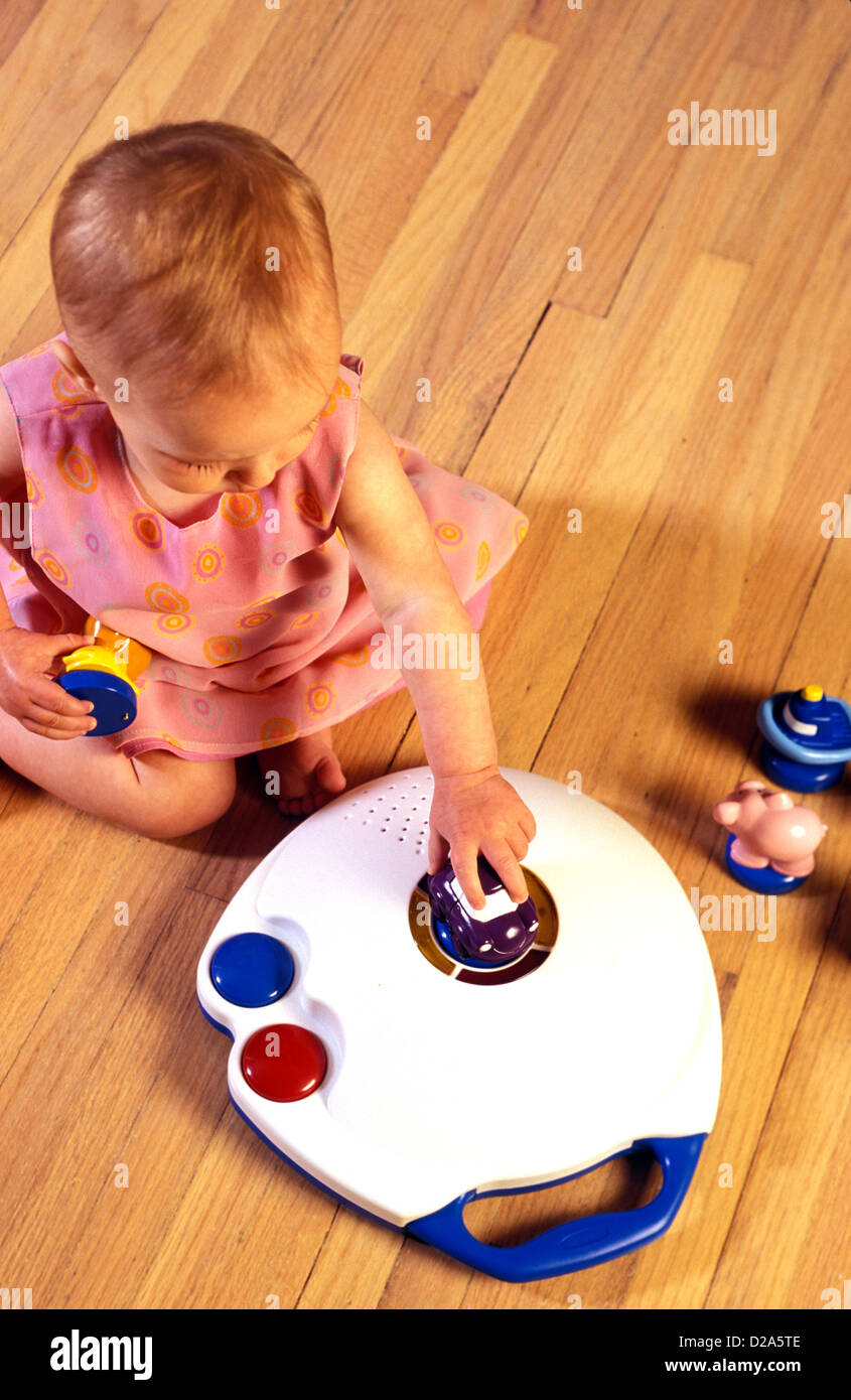 Baby Playing With Language Translating Toy, Little Linguist. Stock Photo