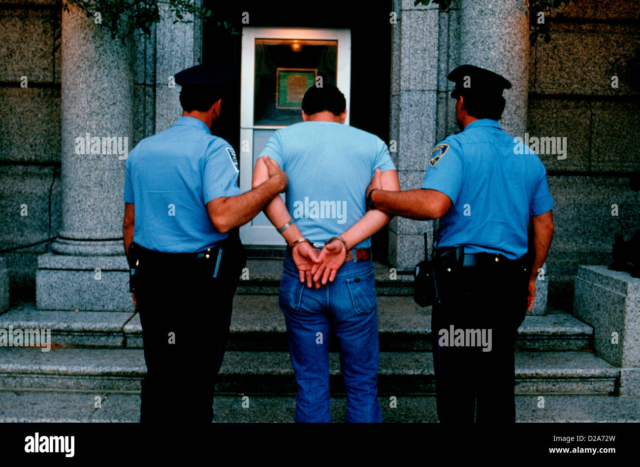 Police With Suspect, Hands Handcuffed Behind His Back Stock Photo Alamy