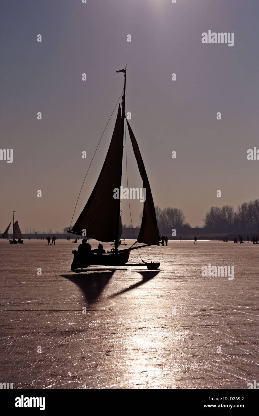 Traditional ice sailing on the Gouwzee in the Netherlands at sunset Stock Photo