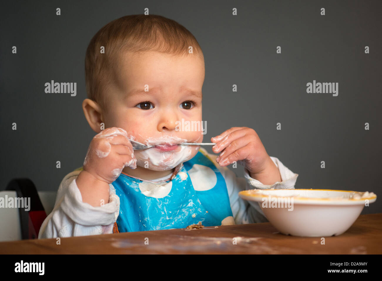 Berlin, Germany, a toddler with Schnute eating yoghurt Stock Photo