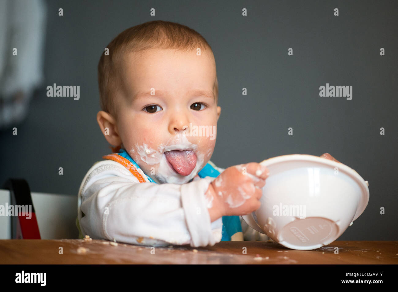 Berlin, Germany, a toddler with Schnute eating yoghurt Stock Photo