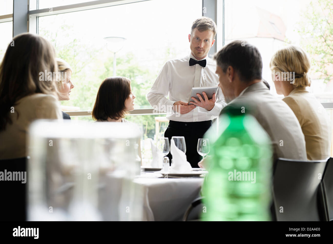Waiter taking order with tablet computer Stock Photo