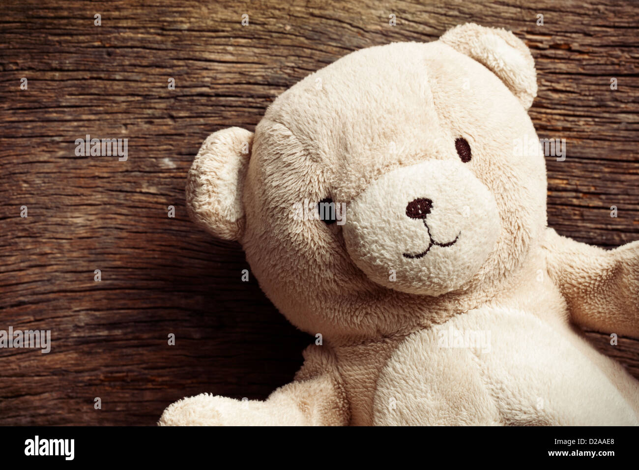 the teddy bear on old wooden background Stock Photo - Alamy