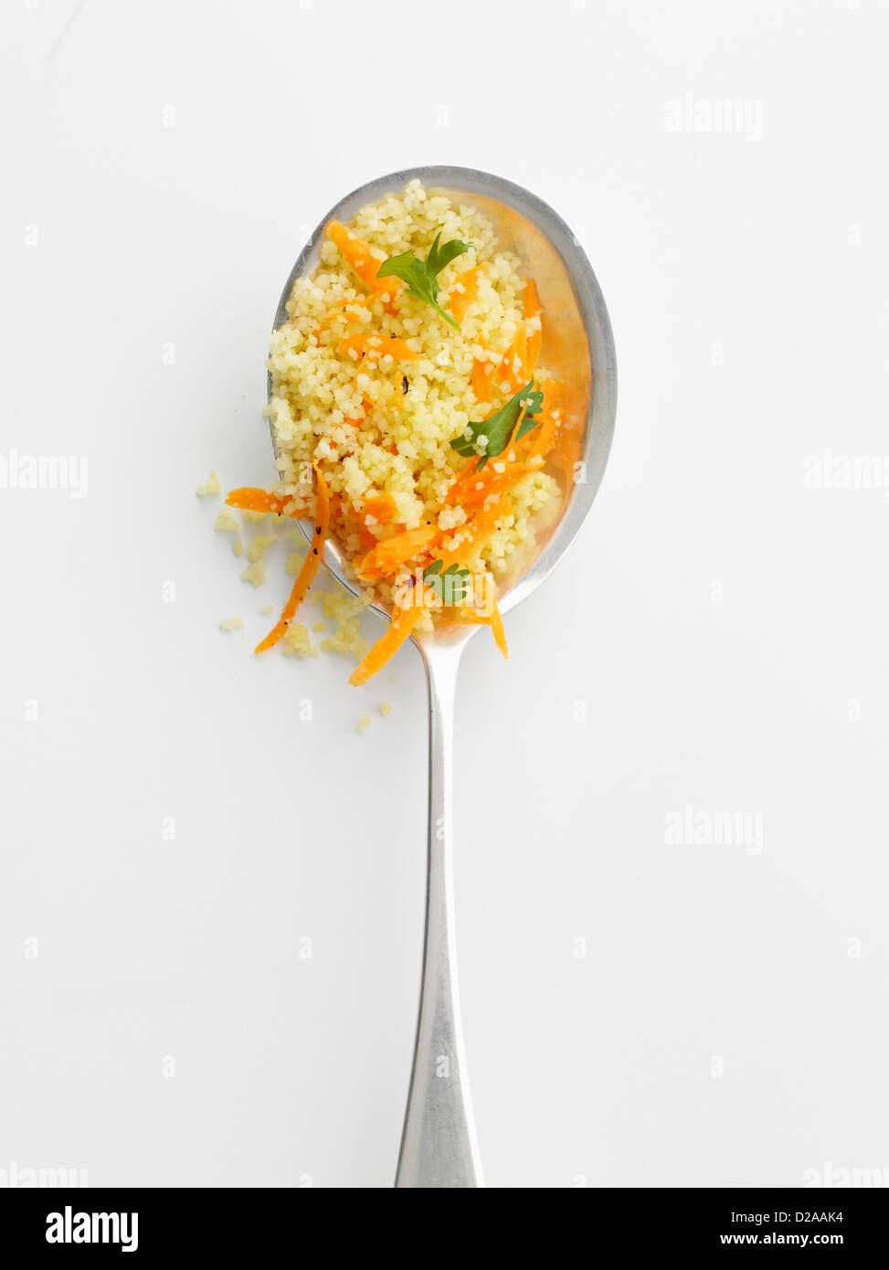 Spoonful of couscous and herbs Stock Photo