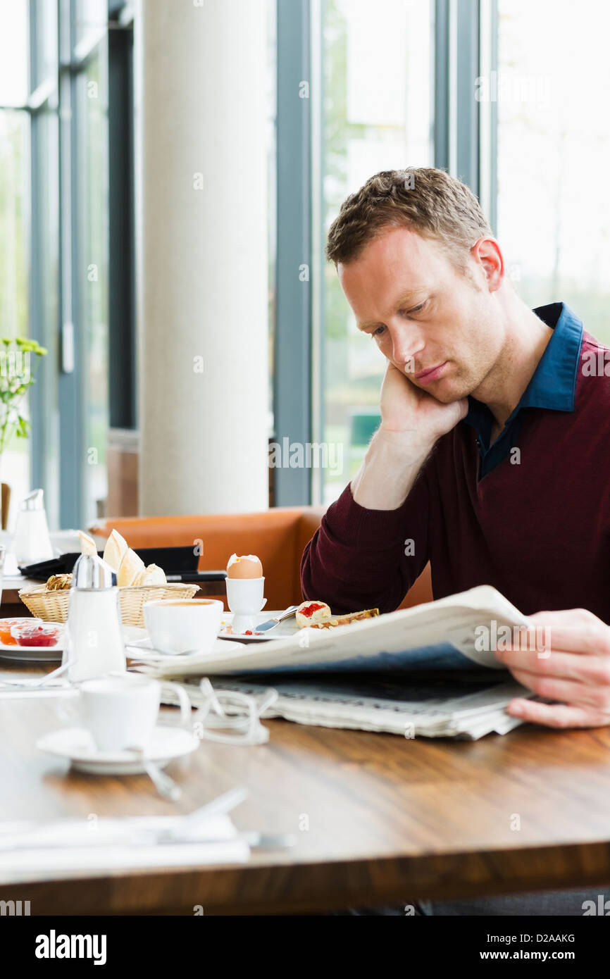 Businessman reading at breakfast Stock Photo