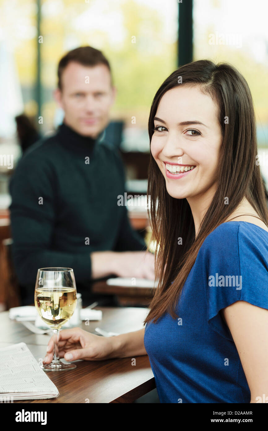 Woman drinking wine in cafe Stock Photo