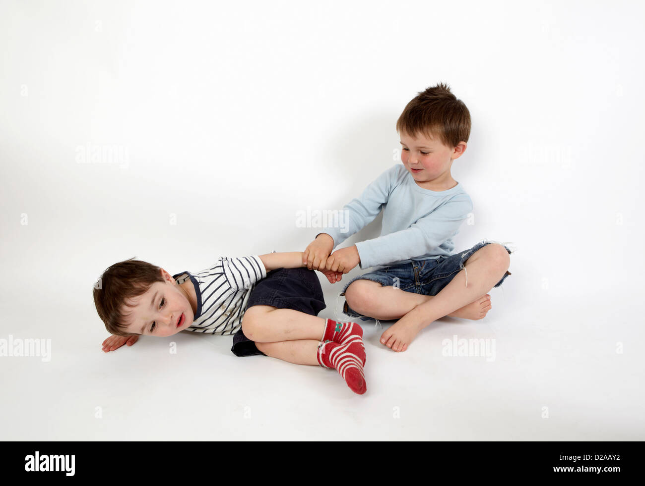 Boys playing together on floor Stock Photo