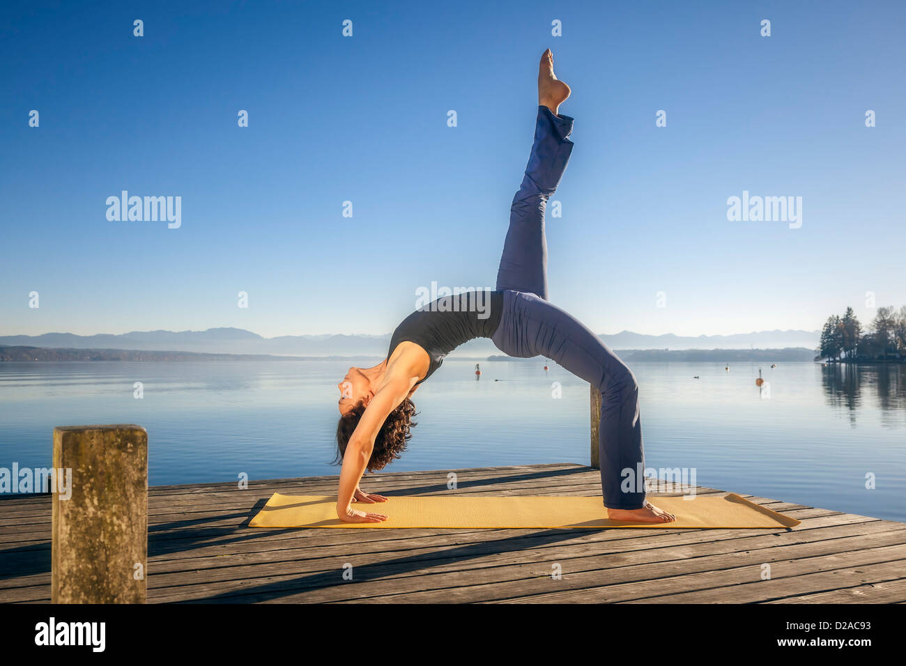 An image of a pretty woman doing yoga at the lake Stock Photo Alamy