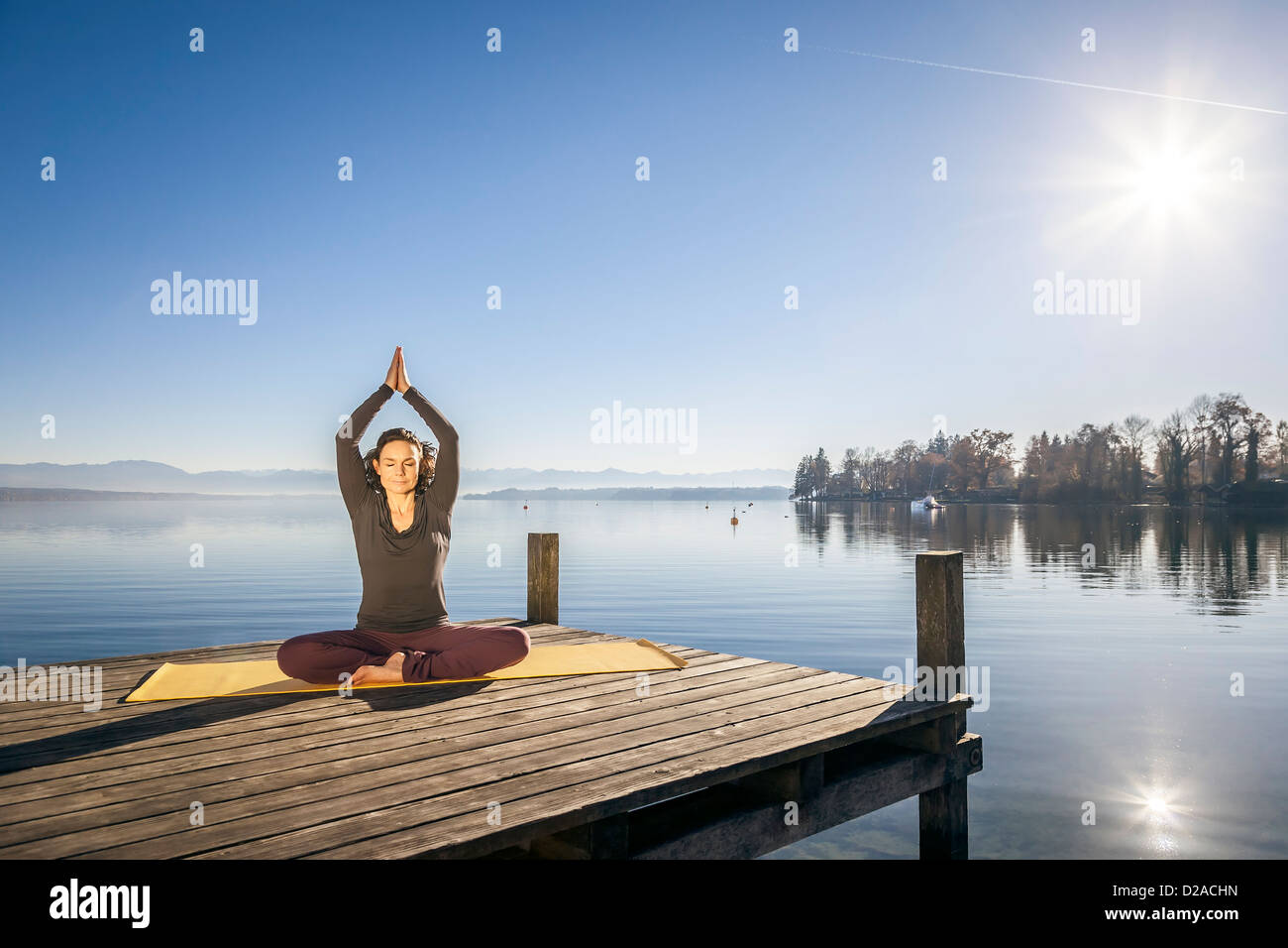 An image of a pretty woman doing yoga at the lake Stock Photo Alamy