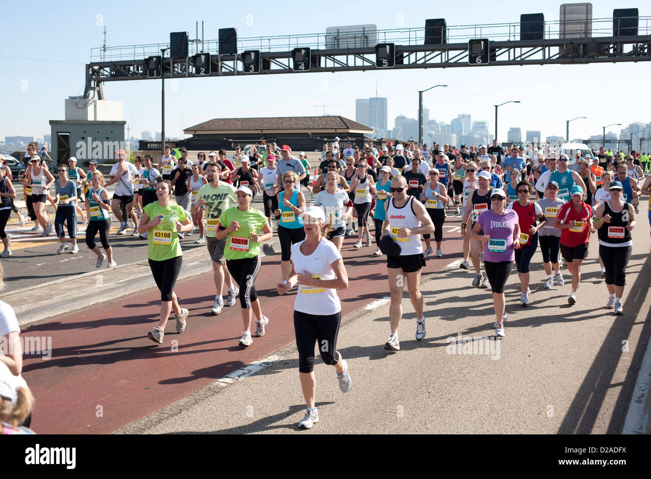 Thousands of fitness enthusiasts running across the Sydney Harbour Bridge in a charity fun run Sydney Australia Stock Photo