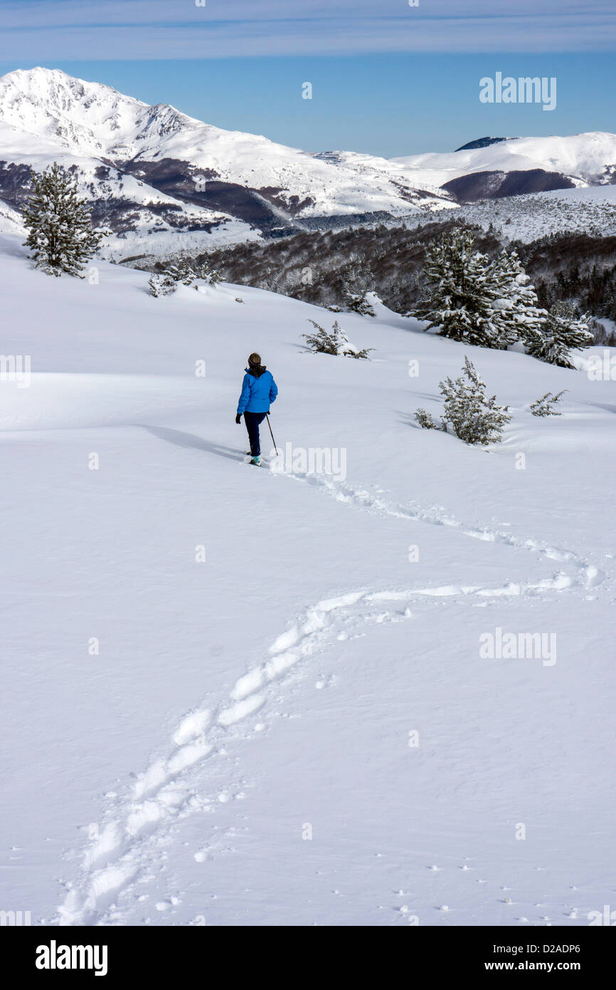 Female dressed in blue, snowshoeing at Beille Plateau, French Pyrenees