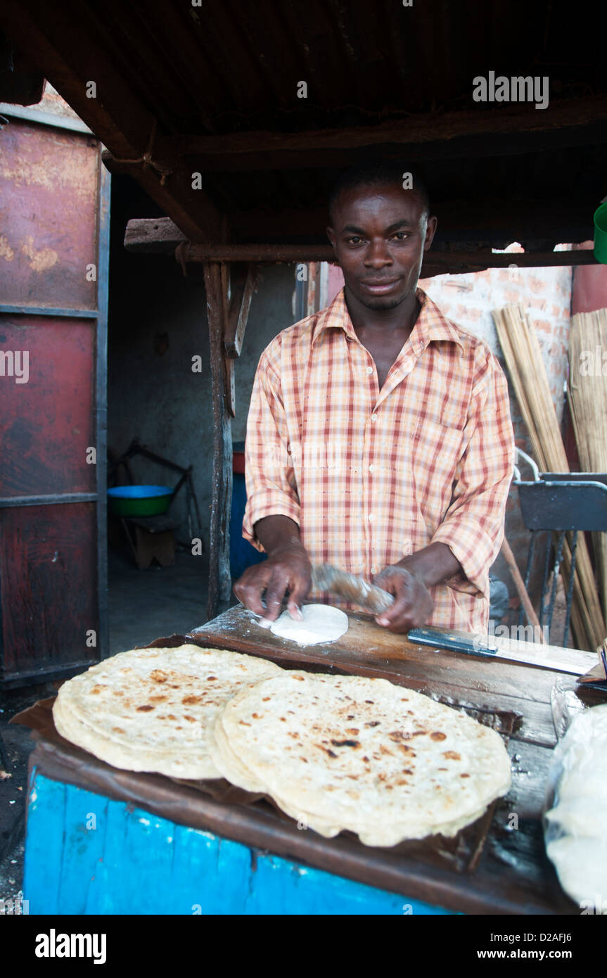 Gulu, Uganda. Man making chapattis (Indian flat bread) at an open air