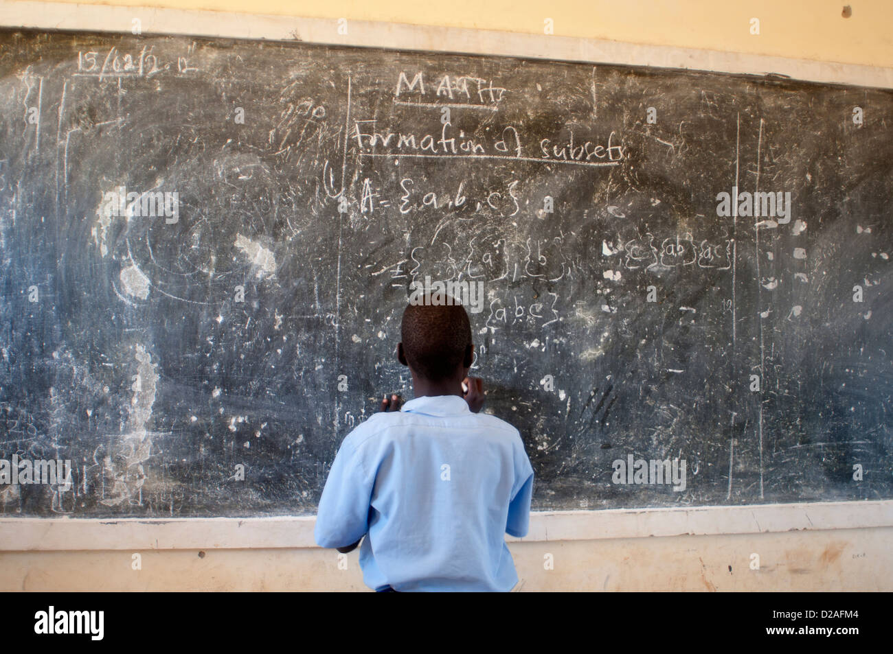 Uganda. Palenga primary school, near Gulu. A girl pupil writes on the blackboard during a maths lesson Stock Photo